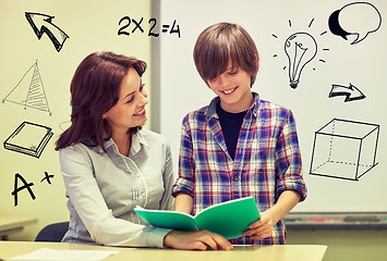 Image showing school boy with notebook and teacher in classroom