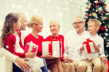 Image showing smiling family with gifts at home