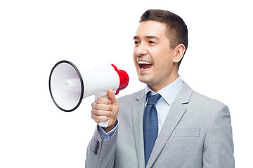 Image showing happy businessman in suit speaking to megaphone