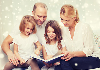 Image showing happy family with book at home