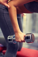 Image showing close up of couple with dumbbell exercising in gym