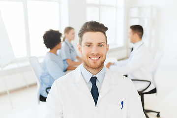 Image showing happy doctor over group of medics at hospital