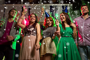 Image showing smiling friends with glasses of champagne in club