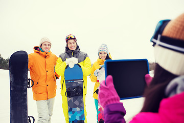 Image showing happy friends with snowboards and tablet pc