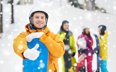 Image showing happy young man with snowboard showing thumbs up