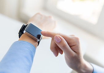 Image showing close up of hands setting smart watch