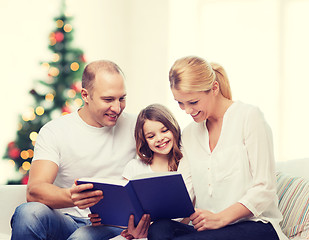 Image showing happy family with book at home