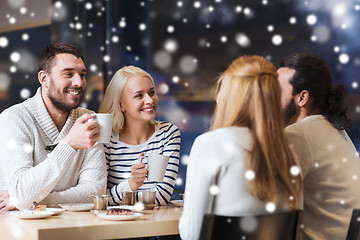 Image showing happy friends meeting and drinking tea or coffee