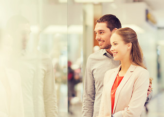 Image showing happy couple looking to shop window in mall