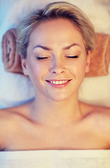 Image showing close up of smiling young woman lying in spa