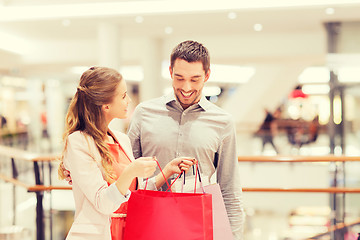 Image showing happy young couple with shopping bags in mall