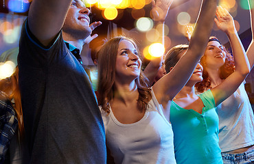 Image showing smiling friends at concert in club