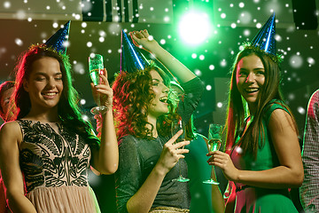 Image showing smiling friends with glasses of champagne in club