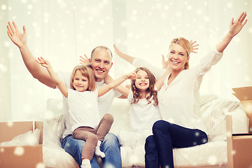 Image showing smiling parents and two little girls at new home