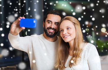 Image showing happy couple with smartphone  and coffee at cafe
