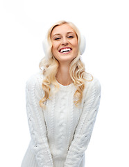 Image showing smiling young woman in winter earmuffs and sweater