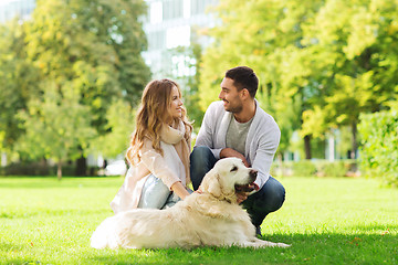 Image showing happy couple with labrador dog walking in city