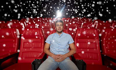 Image showing happy young man watching movie in theater