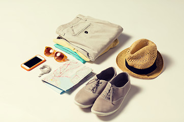 Image showing close up of summer clothes and travel map on table