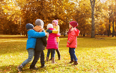 Image showing group of happy children hugging in autumn park