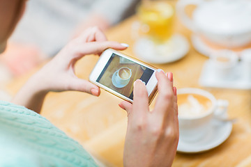 Image showing close up of woman smartphone picturing coffee cup