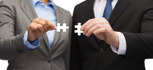 Image showing businessman and businesswoman with puzzle pieces