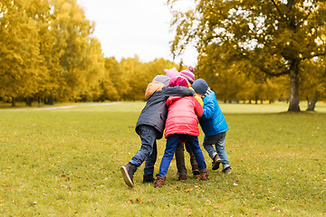 Image showing group of happy children hugging in autumn park