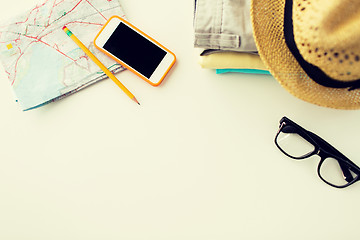 Image showing close up of summer clothes and travel map on table