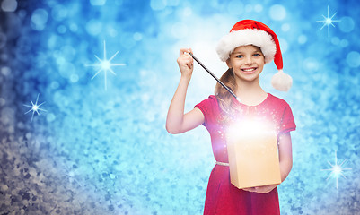 Image showing smiling girl in santa helper hat with gift box