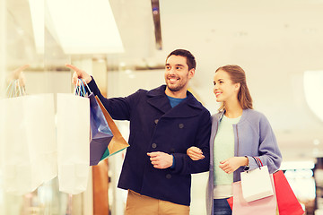 Image showing happy young couple with shopping bags in mall