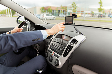 Image showing close up of man with gps navigator driving car