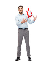 Image showing happy young man playing with gift box