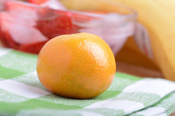 Image showing many different fruits for the health of the entire family, peach, mandarin, strawberry slices