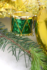 Image showing Christmas background with drums, green eve tree branch, golden new year decoration 