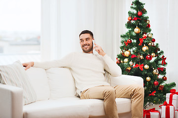 Image showing man calling on smartphone at home for christmas