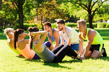 Image showing group of friends or sportsmen exercising outdoors