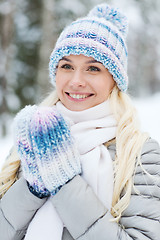 Image showing smiling young woman in winter forest