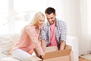Image showing happy couple with parcel box at home
