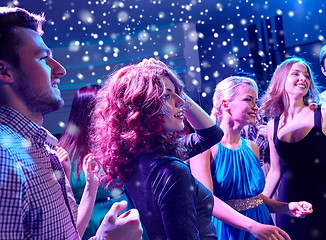 Image showing smiling friends dancing in club