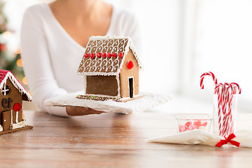 Image showing close up of woman showing gingerbread house