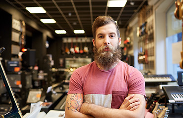 Image showing assistant or customer with beard at music store