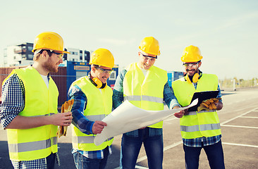 Image showing group of builders with tablet pc and blueprint