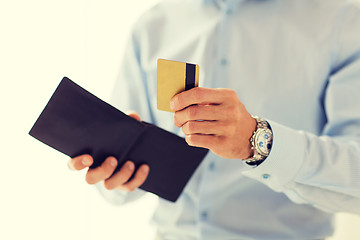 Image showing close up of man holding wallet and credit card