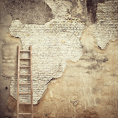 Image showing weathered stucco wall with wooden ladder