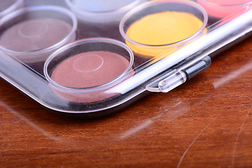 Image showing Watercolor paints set on wooden background