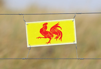 Image showing Border fence - Old plastic sign with a flag