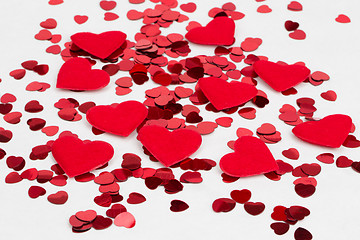 Image showing Red hearts confetti and fabric heart