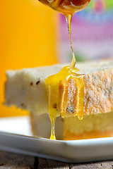 Image showing Honey pouring over bread