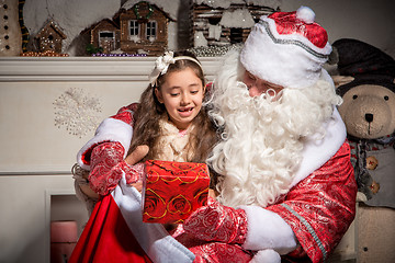 Image showing holidays and people concept - smiling little girl with santa claus 