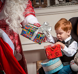 Image showing holidays and people concept - smiling little boy with santa claus 